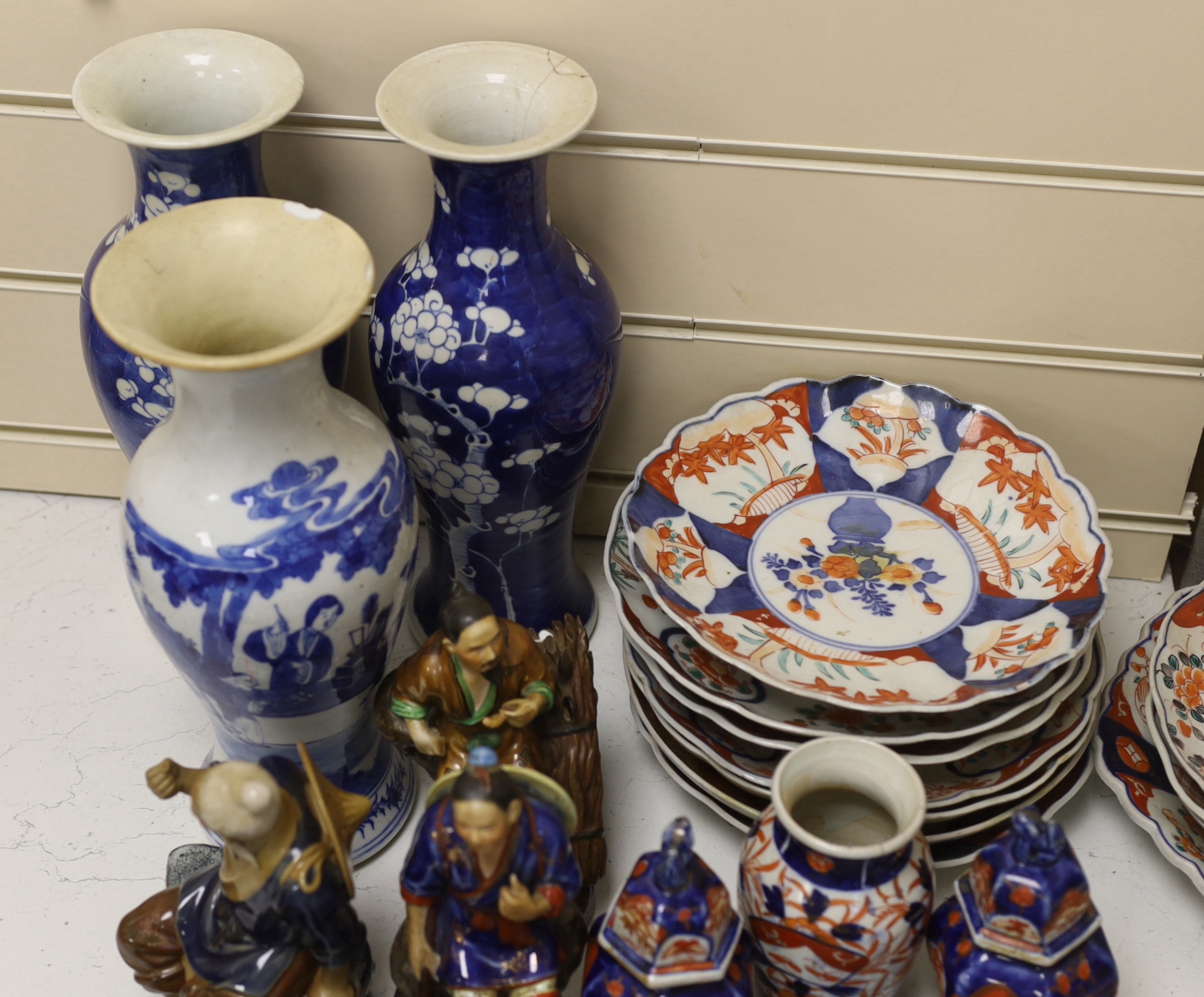 A collection of Chinese and Japanese pottery and porcelain including three vases, five figures, plates and bowls, vases 30cm